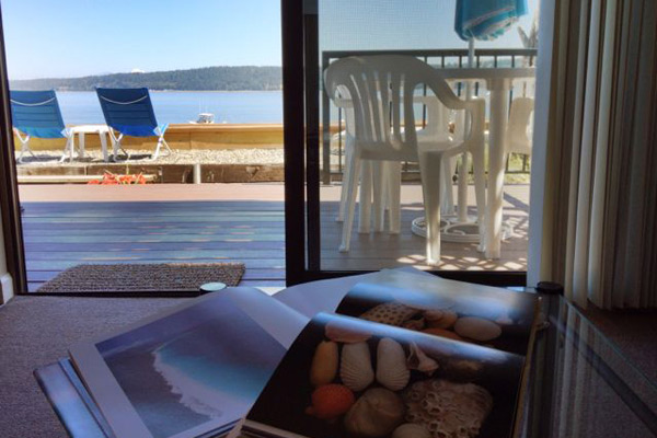 Relaxing on the livingroom sofa at The Beach House at Tyee, you'll be tempted to put down your book to gaze outside at the gorgeous view.